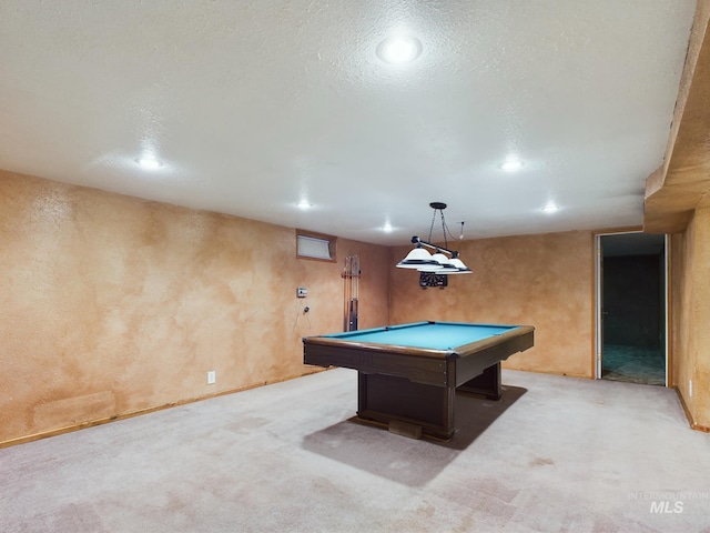 playroom with light colored carpet, a textured ceiling, and pool table