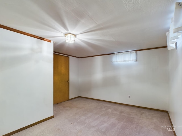 unfurnished room with light colored carpet and a textured ceiling