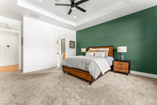 carpeted bedroom featuring a raised ceiling, ceiling fan, and ornamental molding