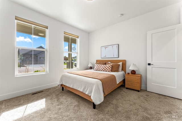 bedroom featuring light colored carpet