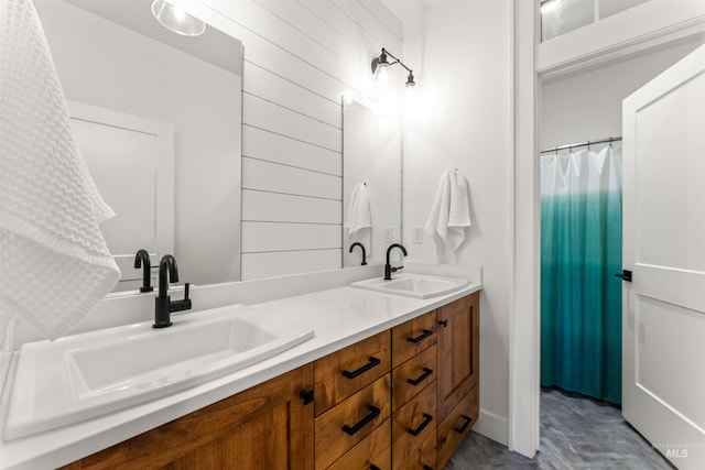 bathroom featuring vanity and wooden walls