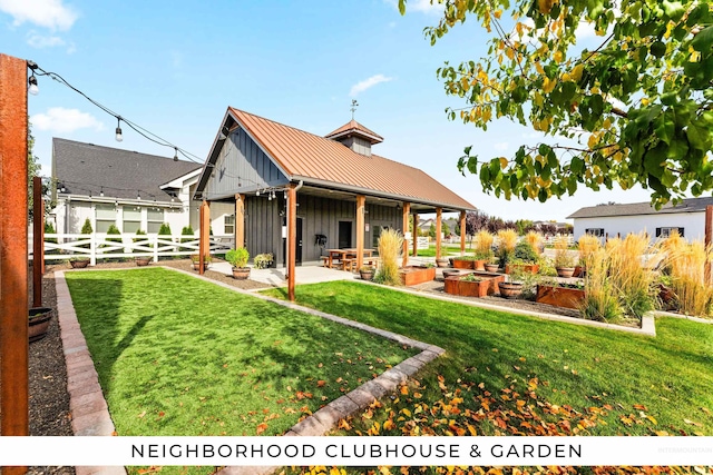 back of house with a patio and a lawn