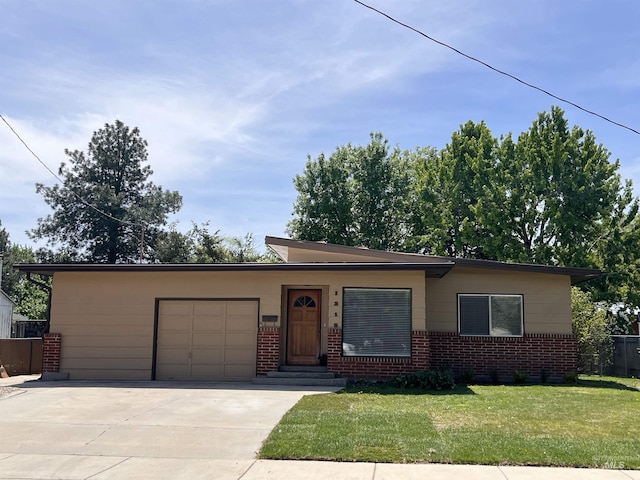 1315 W Howard, Boise, ID 83706 - mid-century modern home featuring an attached garage, concrete driveway, and brick siding