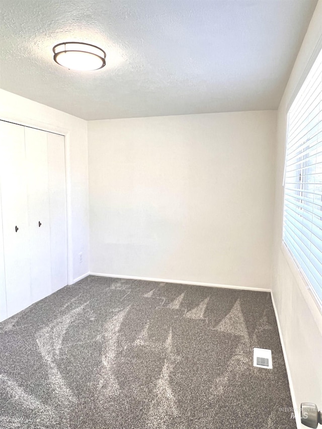 1315 W Howard, Boise, ID 83706 - unfurnished bedroom with carpet floors, a closet, a textured ceiling, and baseboards