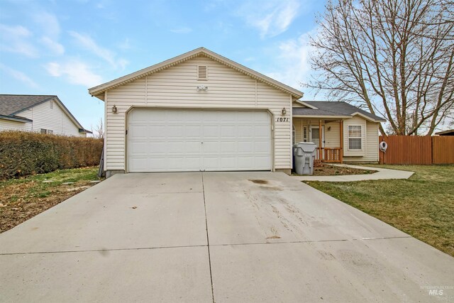 ranch-style house with concrete driveway, an attached garage, and fence