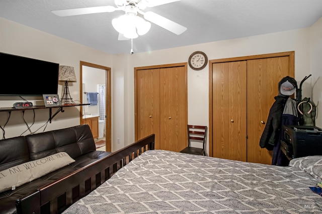 bedroom with a ceiling fan, ensuite bathroom, and multiple closets