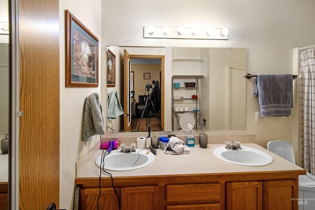 full bath featuring a sink and double vanity