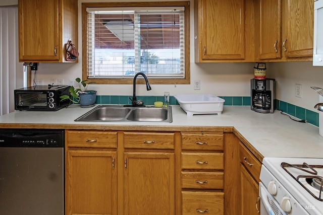 kitchen with dishwasher, light countertops, white range with gas cooktop, brown cabinets, and a sink