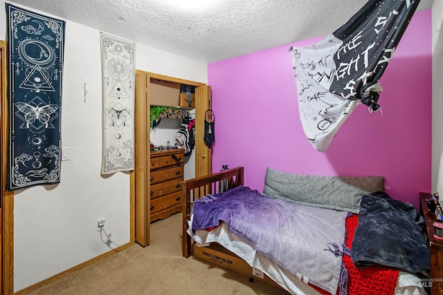 bedroom featuring a textured ceiling, baseboards, and carpet floors