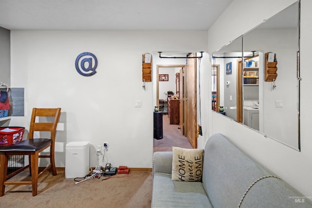 interior space featuring baseboards, carpet floors, and washing machine and clothes dryer