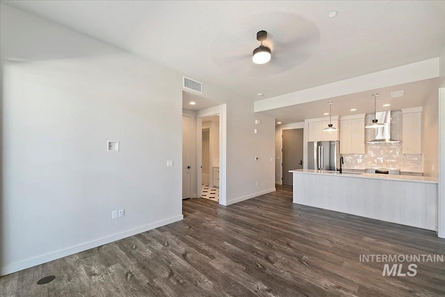 unfurnished living room with dark hardwood / wood-style flooring and sink