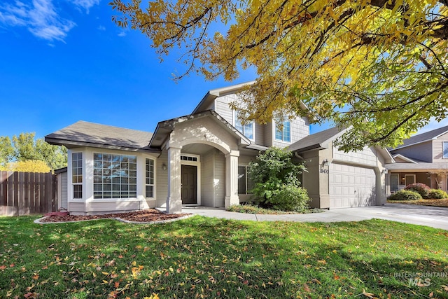 view of front of house featuring a front yard and a garage