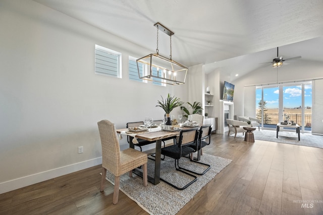 dining space featuring ceiling fan with notable chandelier and hardwood / wood-style floors