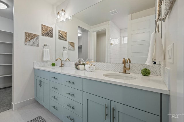 bathroom featuring tile patterned flooring, vanity, and decorative backsplash