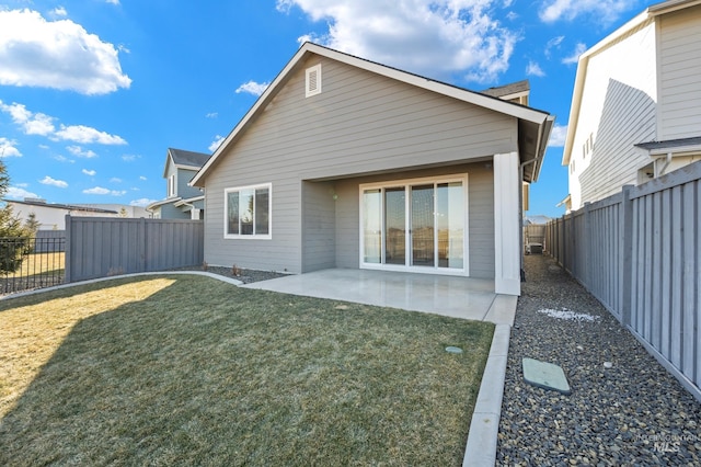 rear view of property featuring a patio and a yard