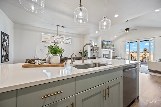 kitchen featuring sink, vaulted ceiling, dark hardwood / wood-style floors, pendant lighting, and ceiling fan