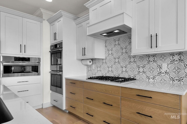 20138 Carbondale Ave, Caldwell, ID 83605 - kitchen featuring custom exhaust hood, appliances with stainless steel finishes, white cabinets, and backsplash