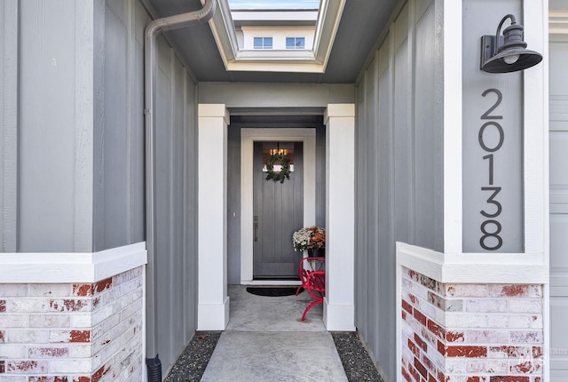 doorway to property featuring brick siding