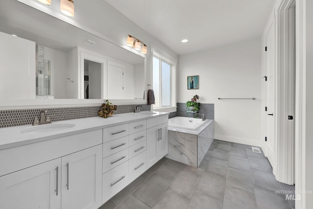 20138 Carbondale Ave, Caldwell, ID 83605 - bathroom featuring double vanity, visible vents, tile patterned floors, a sink, and a bath