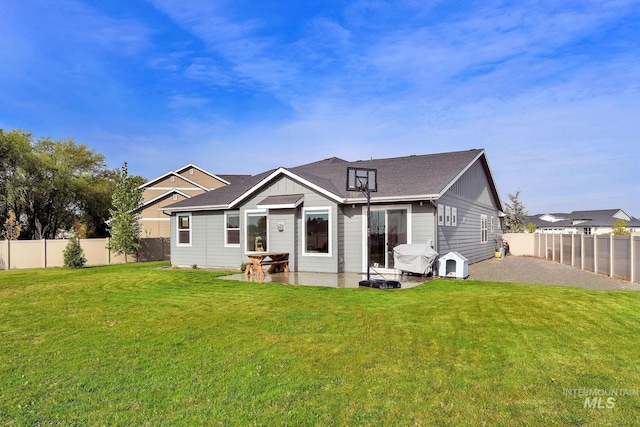 20138 Carbondale Ave, Caldwell, ID 83605 - back of house with a fenced backyard, a lawn, and a patio