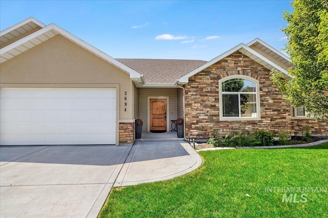 2694 Meadowbrook Dr, Twin Falls, ID 83301 - ranch-style house featuring stone siding, a garage, driveway, and a front yard