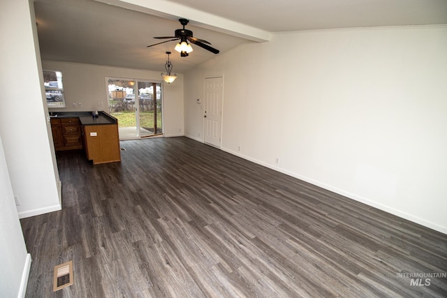 unfurnished living room featuring ceiling fan, dark wood-type flooring, and vaulted ceiling with beams