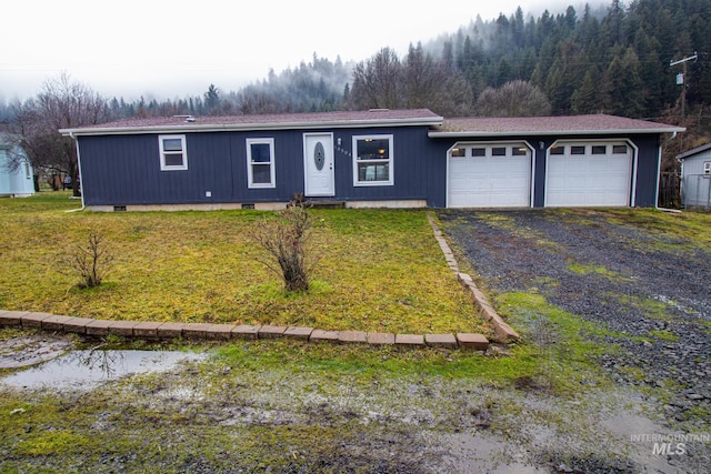 view of front facade with a front yard and a garage