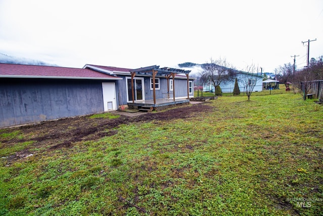 view of yard with a wooden deck and a pergola