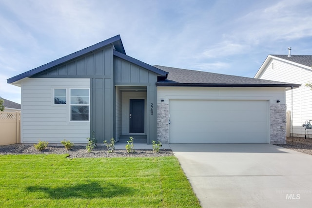 1722 SW Besra Dr, Mountain Home, ID 83647 - view of front of home featuring concrete driveway, board and batten siding, an attached garage, and a front yard