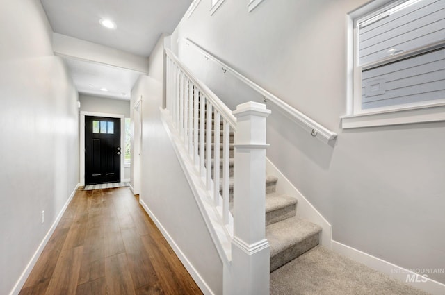 stairway with hardwood / wood-style flooring