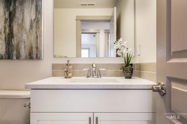 bathroom featuring vanity and toilet