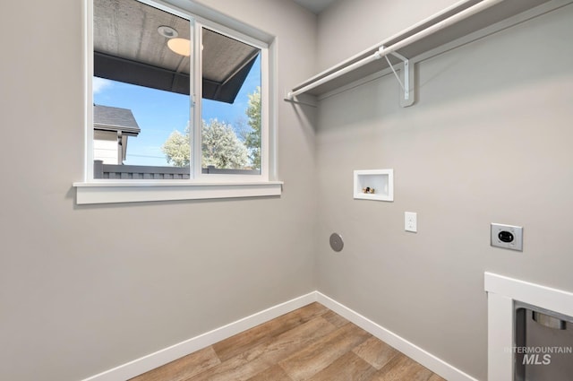 clothes washing area featuring electric dryer hookup, hardwood / wood-style floors, and hookup for a washing machine