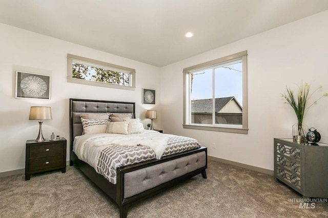 carpeted bedroom featuring multiple windows