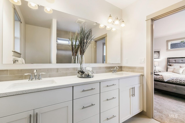 bathroom featuring vanity and backsplash