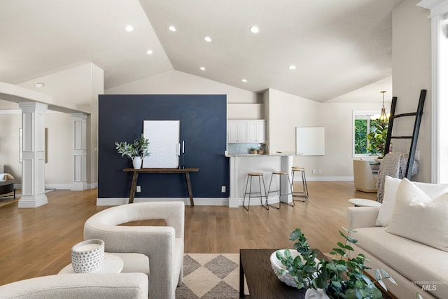 12258 Whitechapel Way, Nampa, ID 83686 - living area with light wood-style floors, decorative columns, high vaulted ceiling, baseboards, and recessed lighting