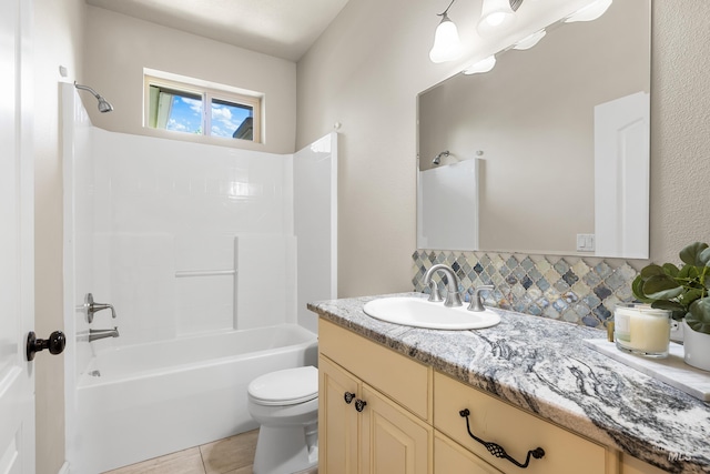 12258 Whitechapel Way, Nampa, ID 83686 - bathroom featuring vanity, toilet, shower / bathtub combination, tile patterned floors, and decorative backsplash