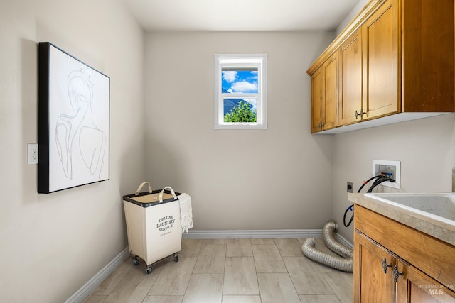 12258 Whitechapel Way, Nampa, ID 83686 - washroom featuring hookup for an electric dryer, cabinet space, baseboards, and hookup for a washing machine