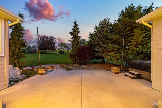 12258 Whitechapel Way, Nampa, ID 83686 - patio terrace at dusk with a patio area, a lawn, and a hot tub