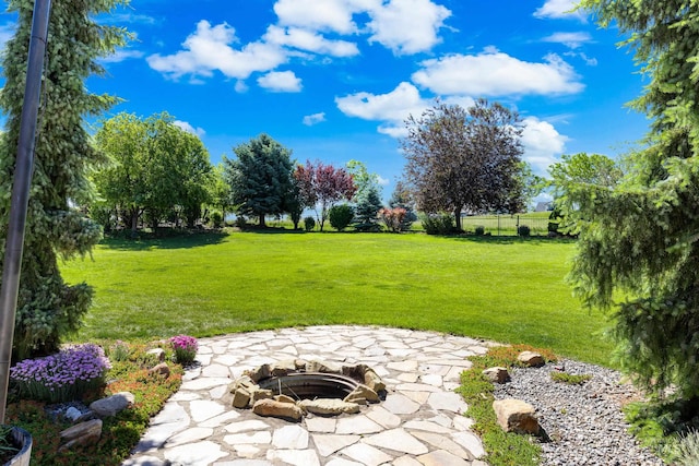 12258 Whitechapel Way, Nampa, ID 83686 - view of green lawn with an outdoor fire pit and a patio