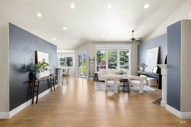 12258 Whitechapel Way, Nampa, ID 83686 - living area with vaulted ceiling, wood finished floors, a textured ceiling, a ceiling fan, and recessed lighting