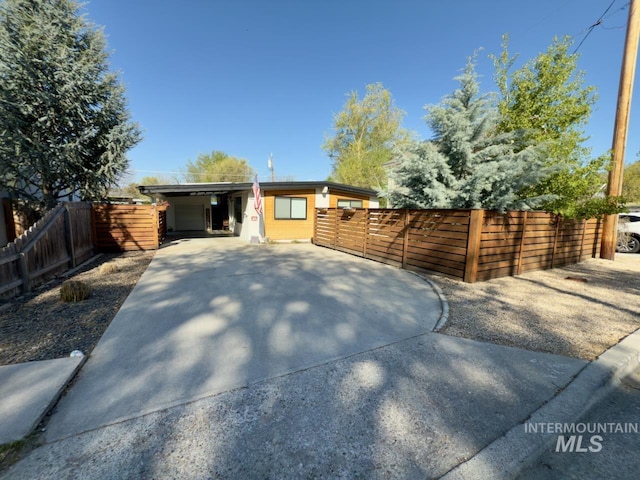 2927 N 32nd St, Boise, ID 83703 - modern home featuring fence, driveway, and an attached carport