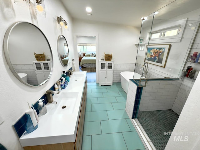 2927 N 32nd St, Boise, ID 83703 - bathroom featuring connected bathroom, tile patterned floors, a stall shower, double vanity, and a freestanding bath