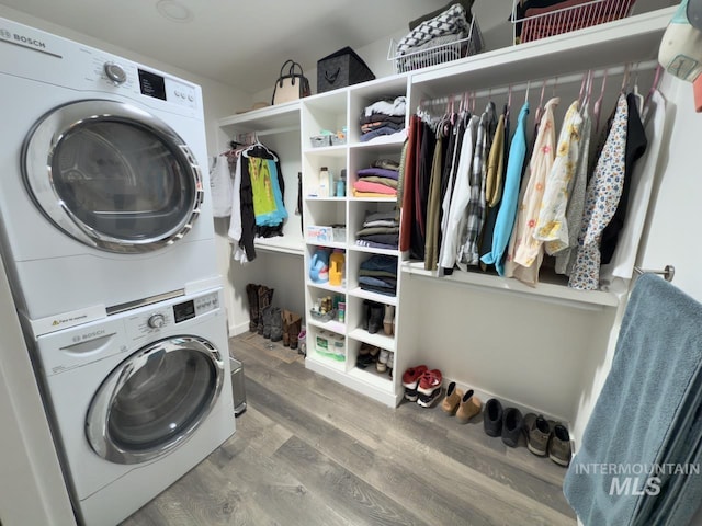 2927 N 32nd St, Boise, ID 83703 - clothes washing area with stacked washing maching and dryer, wood finished floors, and laundry area