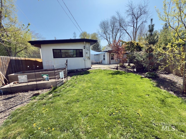 2927 N 32nd St, Boise, ID 83703 - view of yard featuring a patio and a fenced backyard