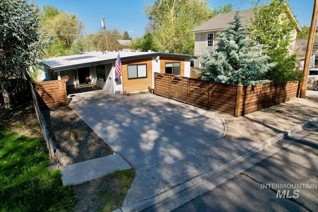2927 N 32nd St, Boise, ID 83703 - view of front facade with driveway, fence, and a carport