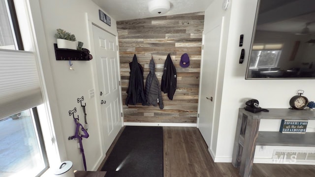 2927 N 32nd St, Boise, ID 83703 - interior space with visible vents, baseboards, wood walls, and dark wood finished floors