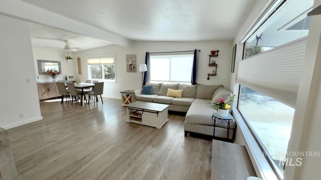 2927 N 32nd St, Boise, ID 83703 - living area featuring beam ceiling, a ceiling fan, light wood-style flooring, and baseboards