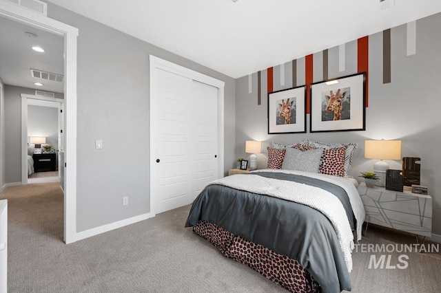 bedroom with visible vents, baseboards, a closet, and carpet flooring