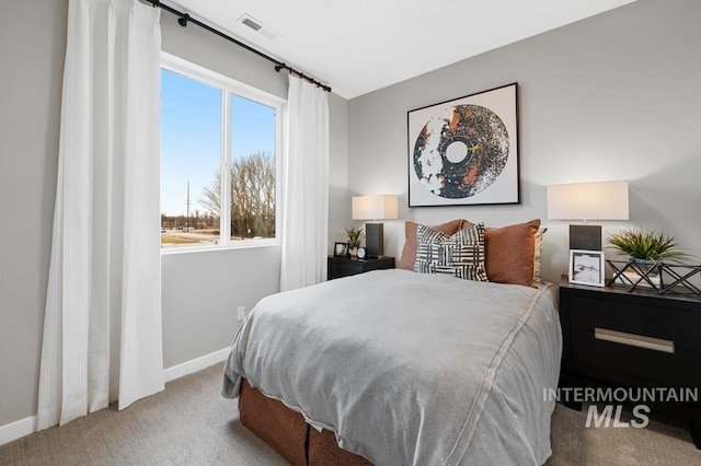 carpeted bedroom with visible vents and baseboards