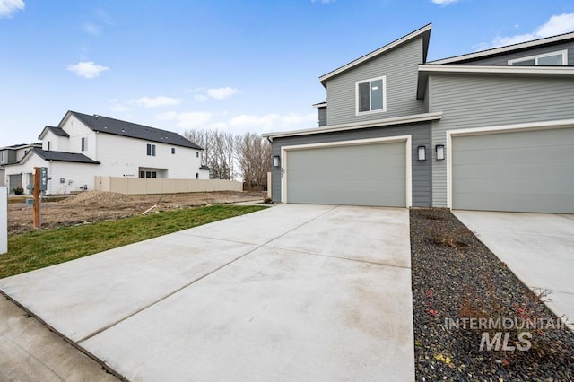 exterior space with concrete driveway and a garage